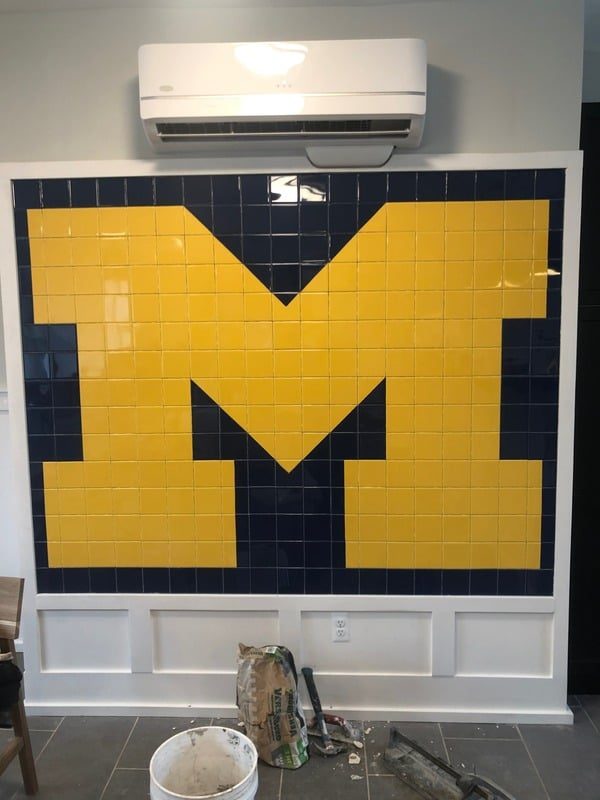 Custom Michigan block M mosaic tile installed on a bathroom accent wall